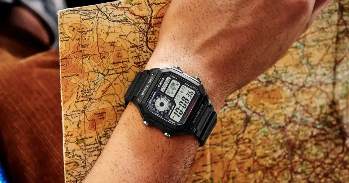 Top 10 First Watches to Kickstart Your Collection for Men 1 a hand wearing a black Casio Ae1200 watch holding a map with the same hand