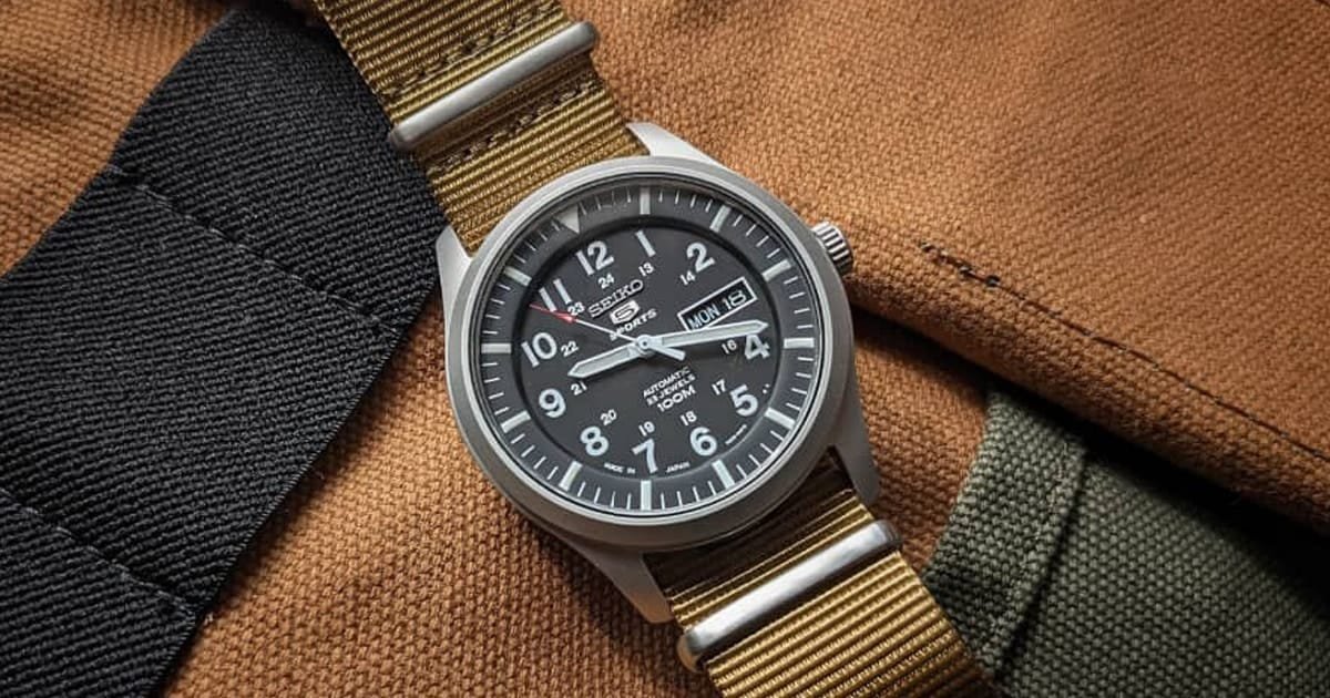 Top 10 First Watches to Kickstart Your Collection for Men 49 Seiko, watch in khaki colour straps and a black dial placed on the backpack, giving the perfect military look.